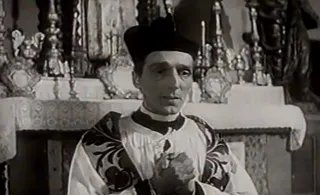 Milan Lentić u ulozi svećenika, kadar iz filma Cesta duga godinu dana (1958.)